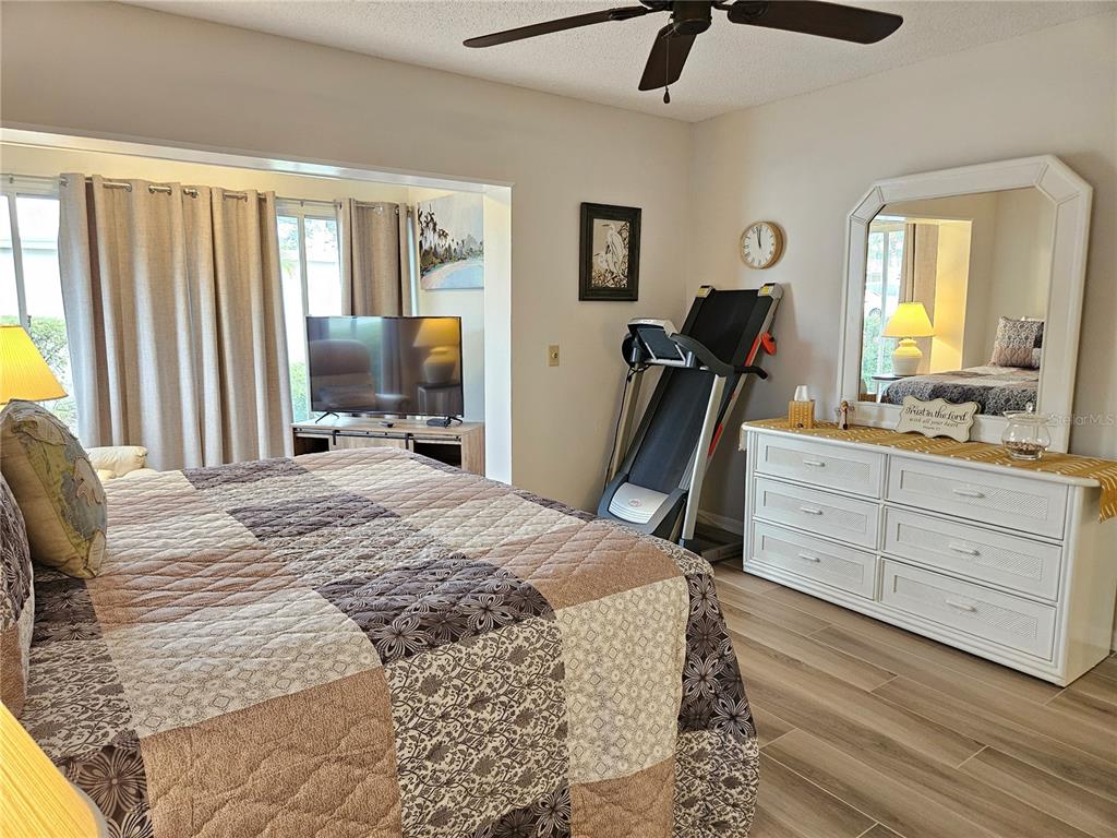 435 Cerromar Lane, Unit 329 Venice, FL 34293 - Photo 41 of 57 a bed room with a bed and a dresser