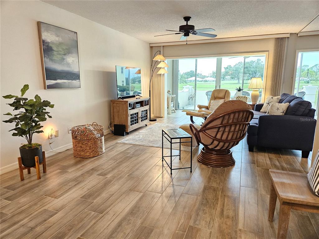 435 Cerromar Lane, Unit 329 Venice, FL 34293 - Photo 7 of 57 a living room with furniture and a large window