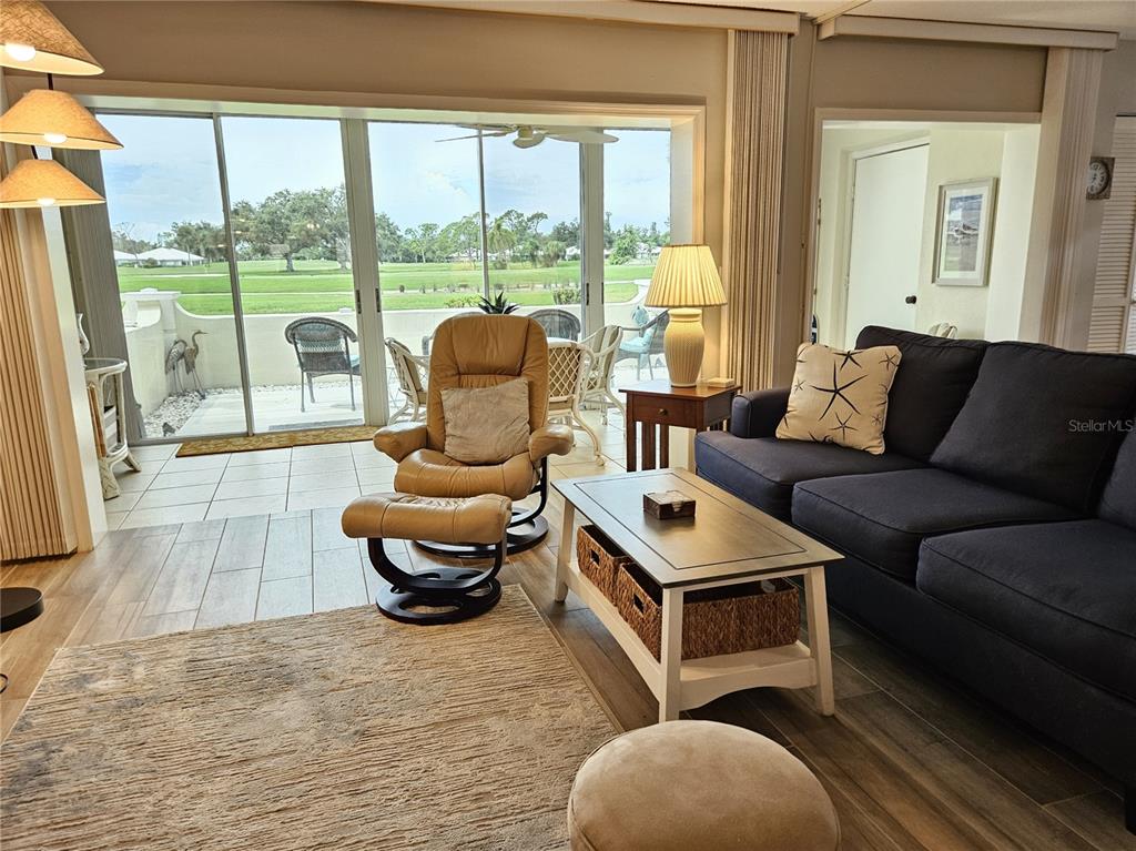 435 Cerromar Lane, Unit 329 Venice, FL 34293 - Photo 10 of 57 a living room with furniture and a large window