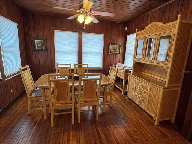 a kitchen with a refrigerator wooden floor and a sink