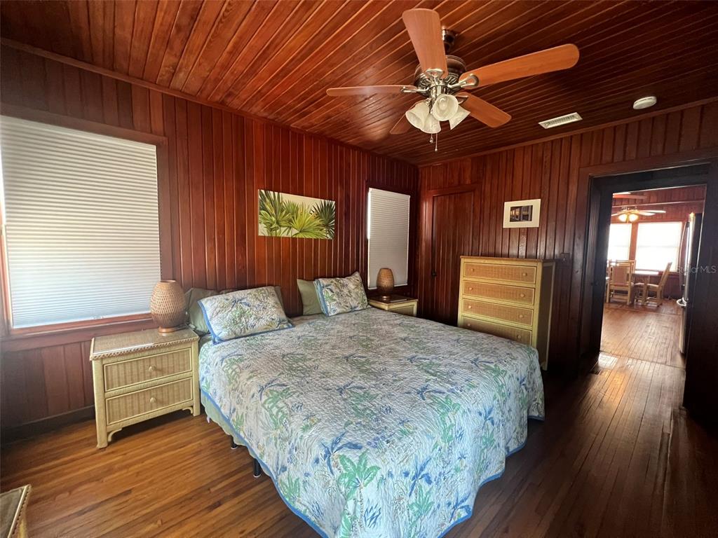 5 82nd Avenue Treasure Island, FL 33706 - Photo 26 of 35 a spacious bedroom with a bed and a chandelier