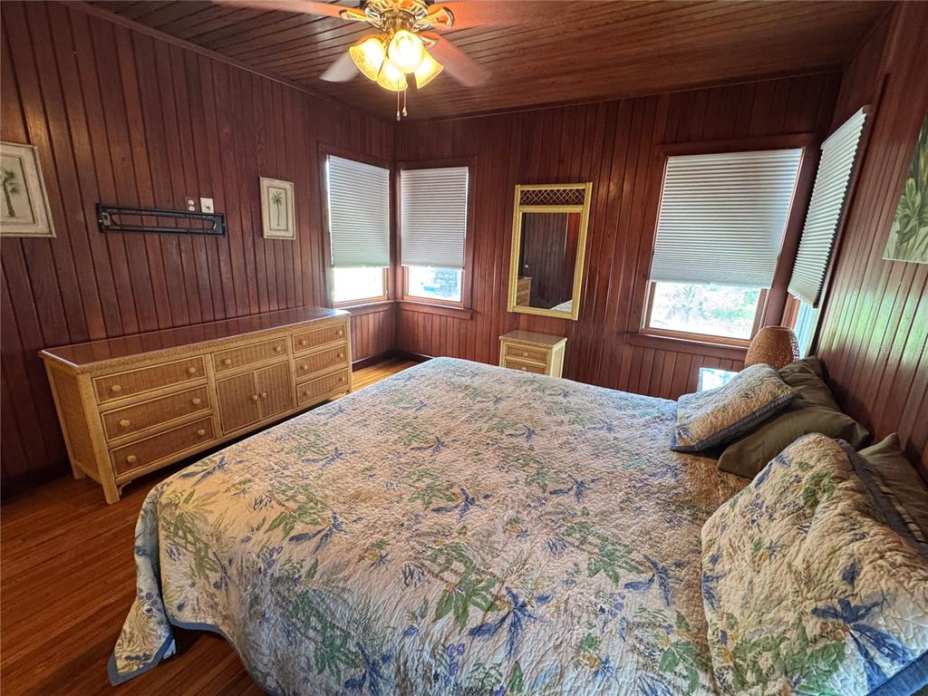 5 82nd Avenue Treasure Island, FL 33706 - Photo 30 of 35 a bedroom with a large bed and a chandelier