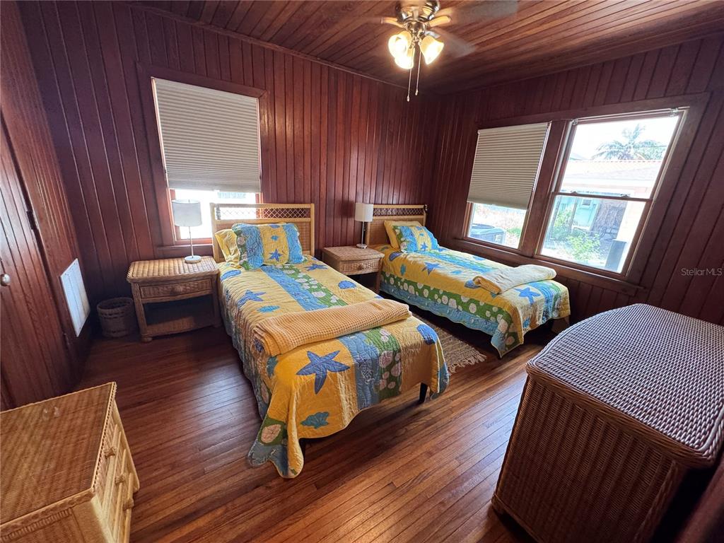 5 82nd Avenue Treasure Island, FL 33706 - Photo 32 of 35 a bedroom with two beds and a chandelier