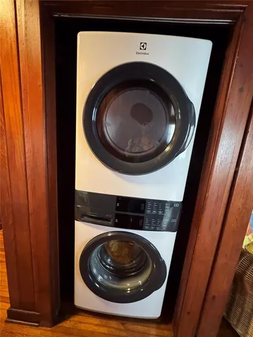 a living room with furniture a ceiling fan and a large window
