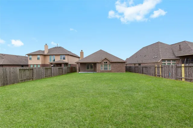 a view of a house with backyard and porch
