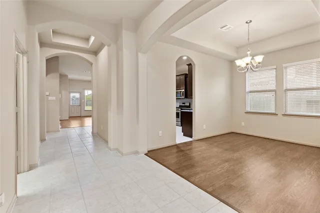 an empty room with windows and entrance