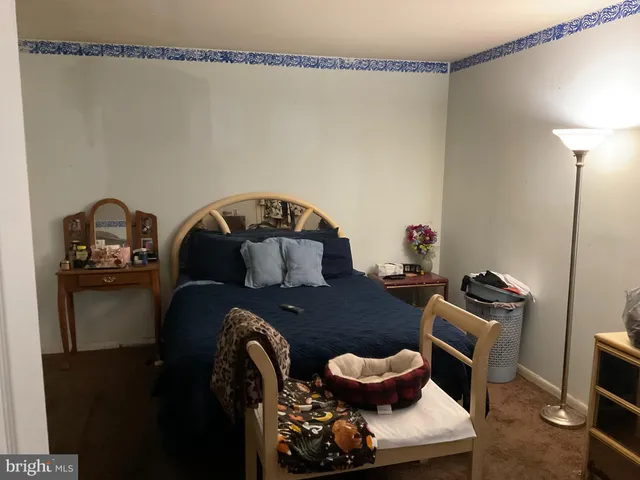 a living room with furniture and a lamp