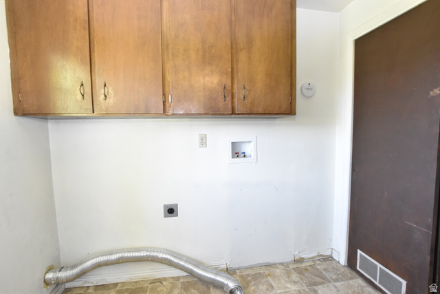 290 West 600 North Logan, UT 84321 - Photo 41 of 45 Utility space with wood-finish upper cabinetry, white walls, and vinyl flooring