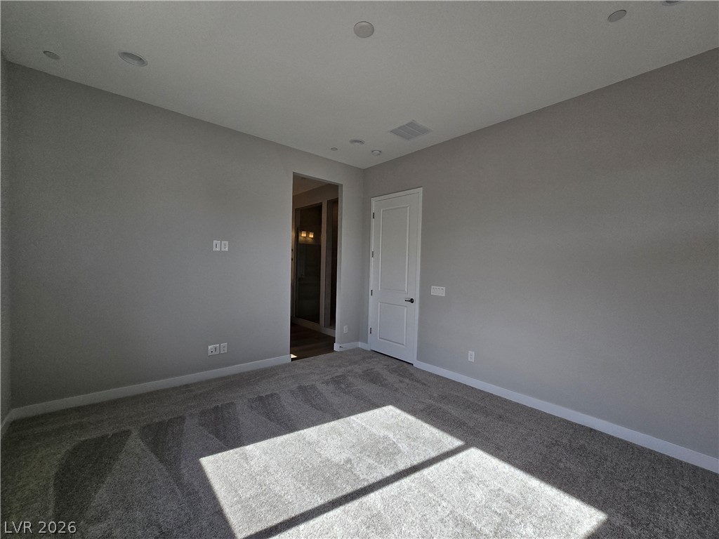 852 Weston Ridge Street Henderson, NV 89011 - Photo 15 of 28 A spacious room offers comfortable carpet flooring and recessed lighting.