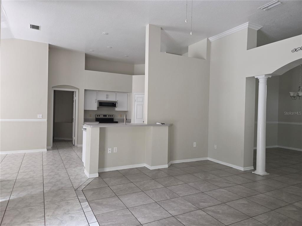 4511 Oak River Circle Valrico, FL 33596 - Photo 12 of 14 a kitchen with a refrigerator and white cabinets
