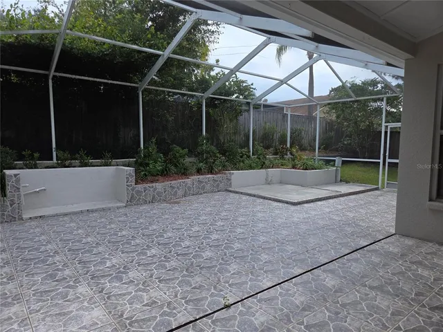 a backyard of a house with lots of green space and plants