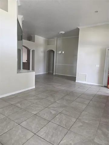 an empty room with entrance and windows