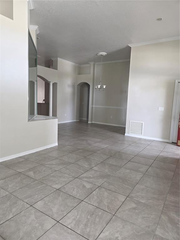 4511 Oak River Circle Valrico, FL 33596 - Photo 3 of 14 an empty room with entrance and windows
