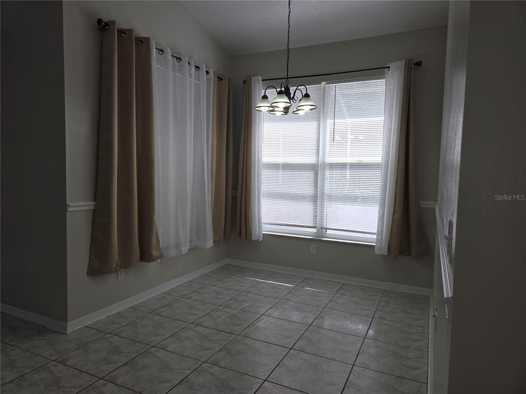 4511 Oak River Circle Valrico, FL 33596 - Photo 5 of 14 a view of empty room with window and chandelier fan