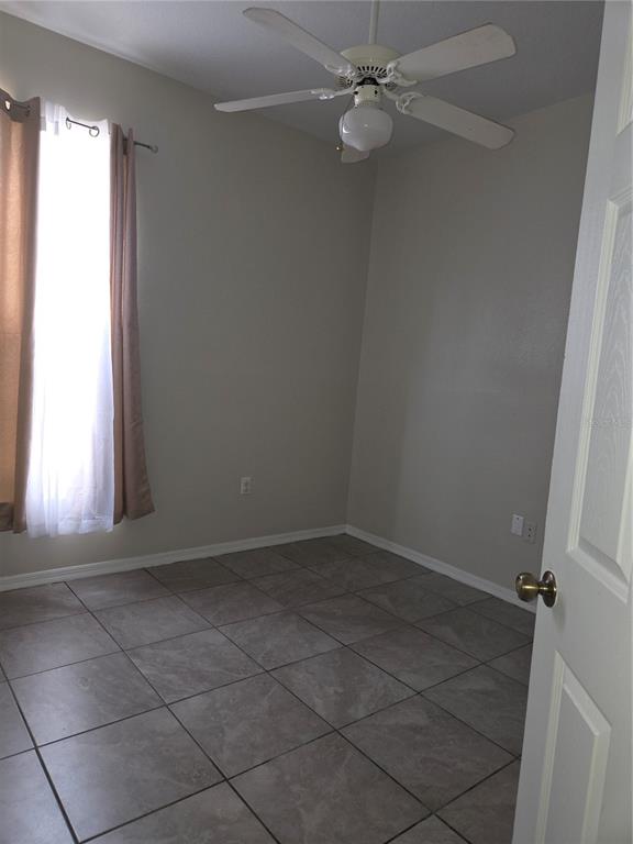 4511 Oak River Circle Valrico, FL 33596 - Photo 8 of 14 an empty room with a window