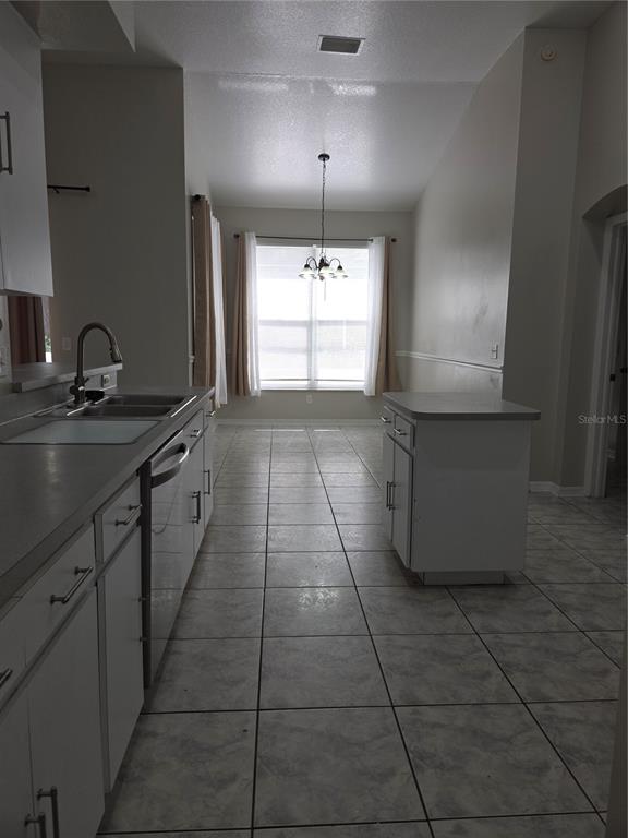 4511 Oak River Circle Valrico, FL 33596 - Photo 9 of 14 a kitchen with a sink a window and cabinets
