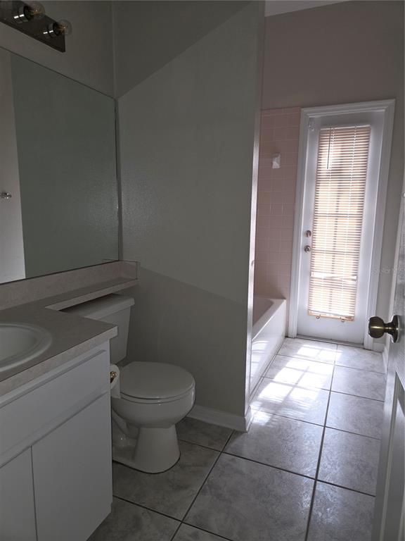 4511 Oak River Circle Valrico, FL 33596 - Photo 10 of 14 a bathroom with a toilet a window and a shower
