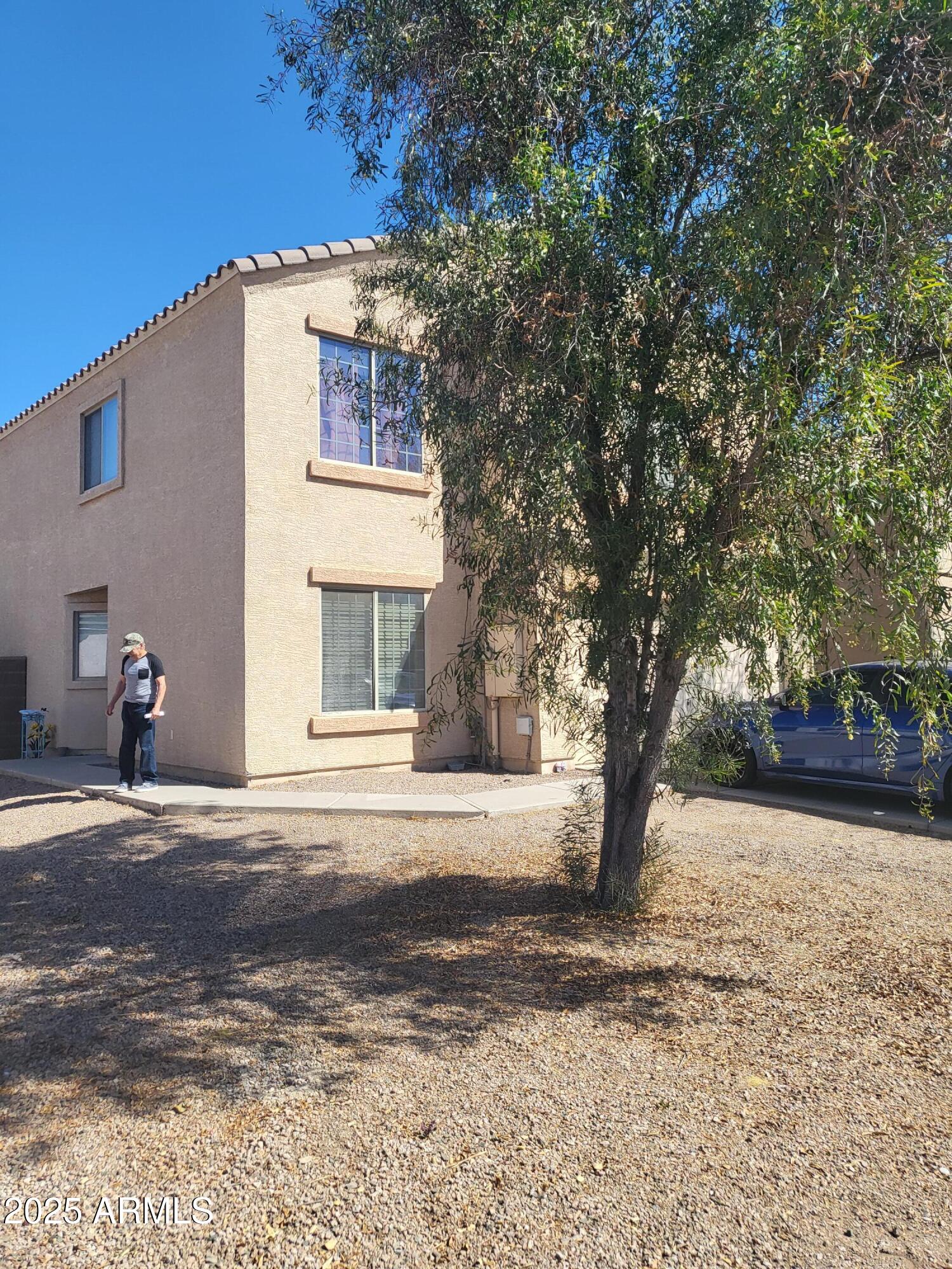43718 West Magnolia Road Maricopa, AZ 85138 - Photo 2 of 21 a front view of a house with a yard and garage