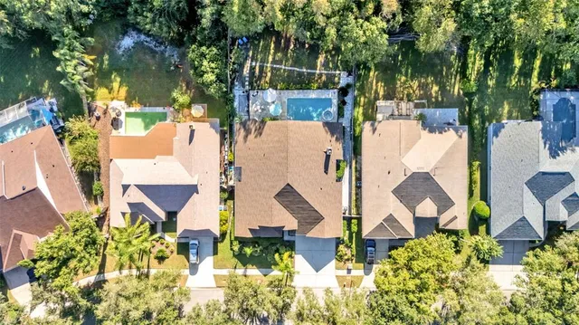 an aerial view of a house with a yard