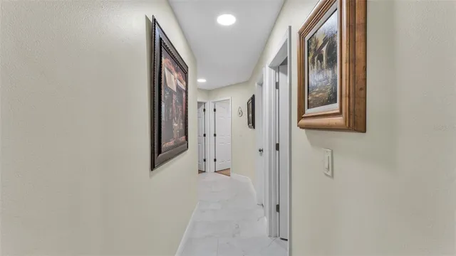 a bedroom with a bed a flat screen tv and a ceiling fan