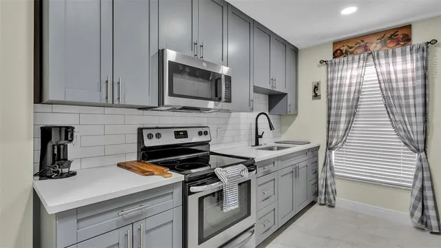 a living room with furniture a chandelier and a flat screen tv