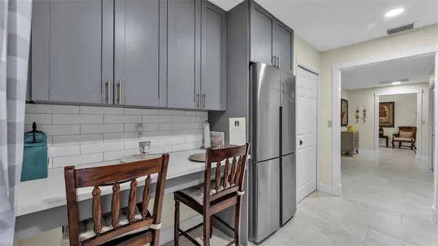 a living room with lots of furniture and kitchen view