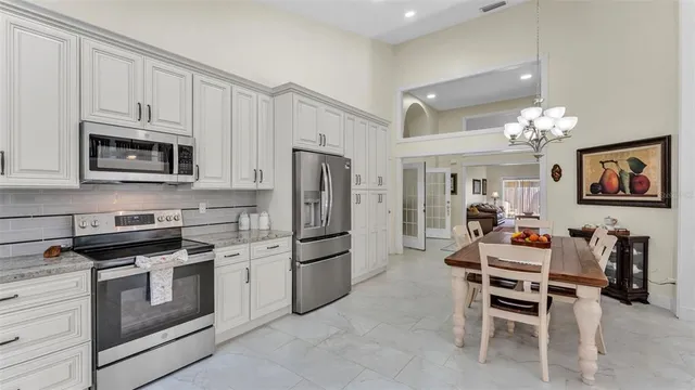 a view of a patio with a table chairs and a floor to ceiling window