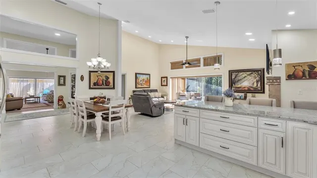 a view of a patio with dining table and chairs under an umbrella