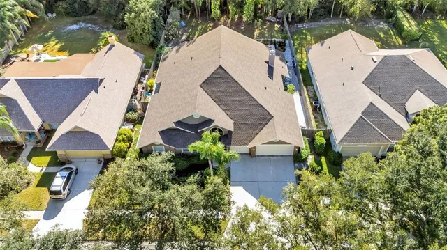 an aerial view of a house with garden space and street view