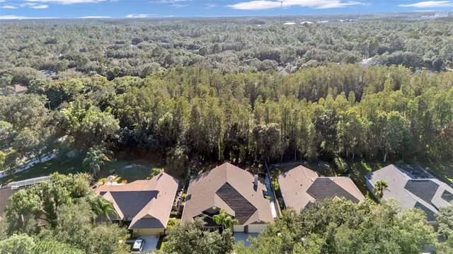 an aerial view of residential house with outdoor space and trees