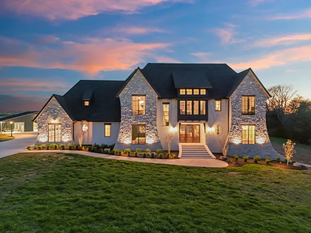 a front view of a house with a garden