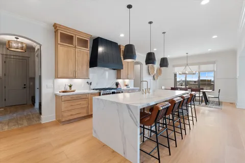 a bedroom with a large bed and a chandelier