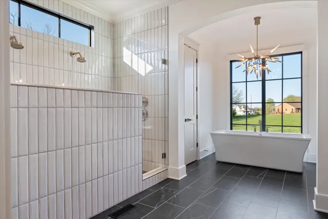a living room with stainless steel appliances furniture and wooden floor