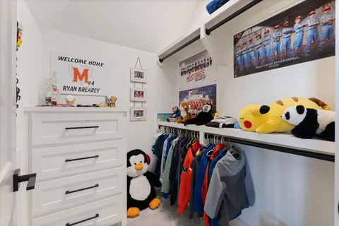 a view of swimming pool with outdoor seating and house in the background