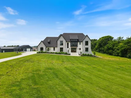 a large kitchen with stainless steel appliances kitchen island granite countertop a stove and a view of living room