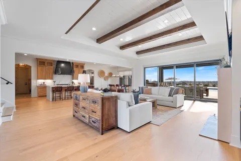 a kitchen with kitchen island granite countertop a sink cabinets and stainless steel appliances