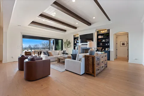 a kitchen with stainless steel appliances kitchen island granite countertop a stove a sink a dining table and chairs