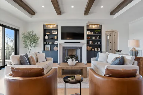 a dining room with furniture a chandelier and wooden floor