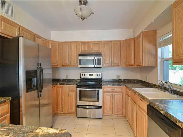 13 Palm Road Sewall's Point, FL 34996 - Photo 13 of 25 a kitchen with stainless steel appliances granite countertop a stove a sink and a refrigerator