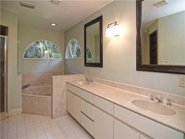 13 Palm Road Sewall's Point, FL 34996 - Photo 18 of 25 a bathroom with a sink and a mirror