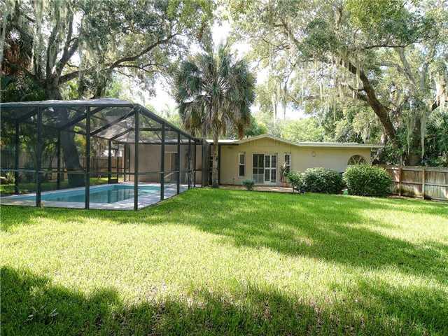 13 Palm Road Sewall's Point, FL 34996 - Photo 4 of 25 a view of a house with a backyard and a tree