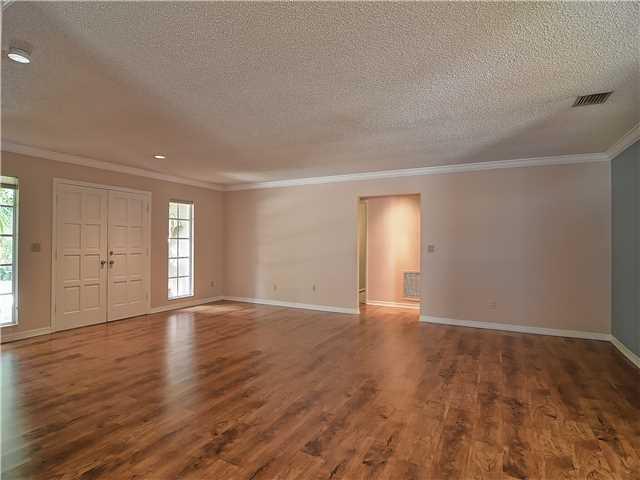 13 Palm Road Sewall's Point, FL 34996 - Photo 8 of 25 a view of an empty room with window and wooden floor