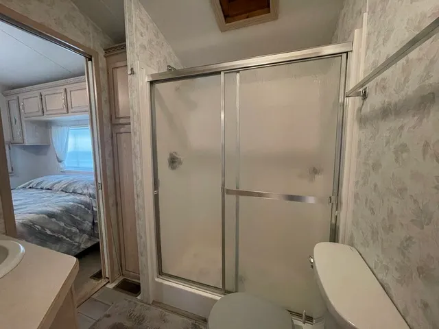 a bathroom with a shower and toilet