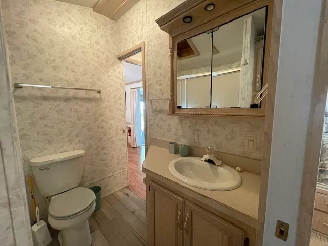 a bathroom with a sink toilet and shower