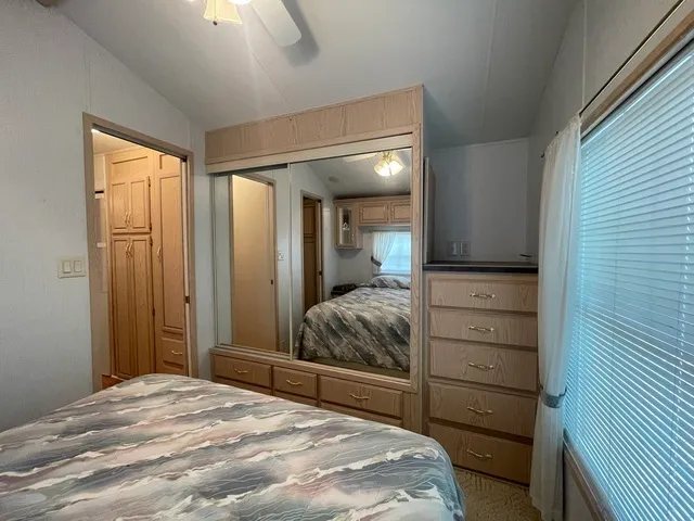 a bedroom with a bed and a dresser