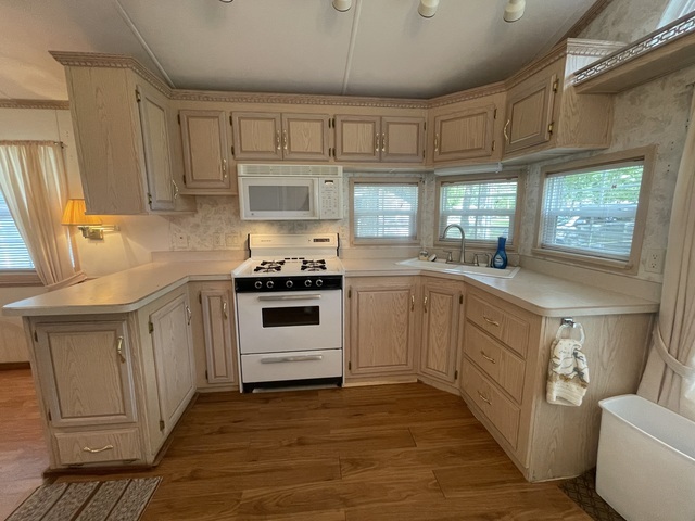 4-52 Woodhaven Lakes Sublette, IL 61367 - Photo 3 of 35 a kitchen with granite countertop a sink cabinets stainless steel appliances and a window