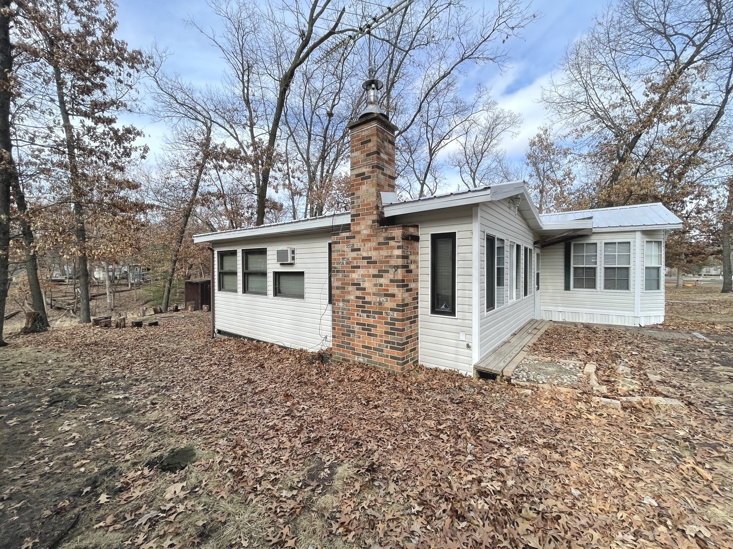 4-52 Woodhaven Lakes Sublette, IL 61367 - Photo 31 of 35 a view of a house with a large tree and wooden fence
