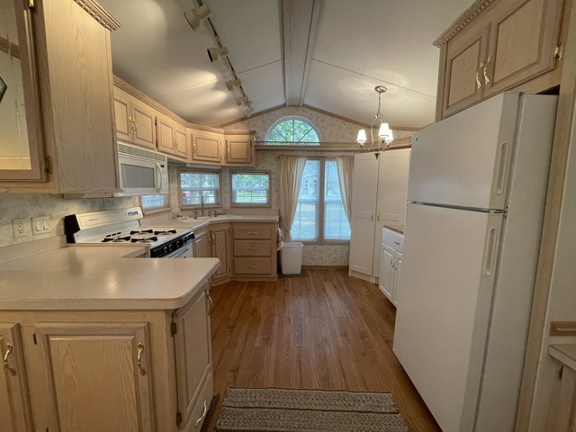 4-52 Woodhaven Lakes Sublette, IL 61367 - Photo 4 of 35 a kitchen with a refrigerator a stove a sink and a window