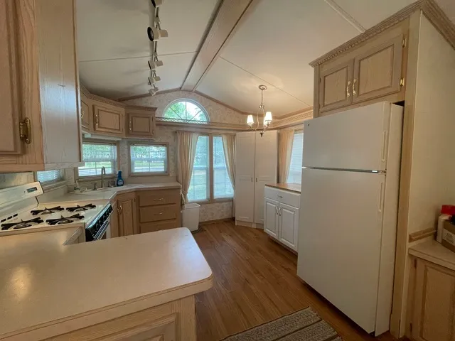 a kitchen with refrigerator and window