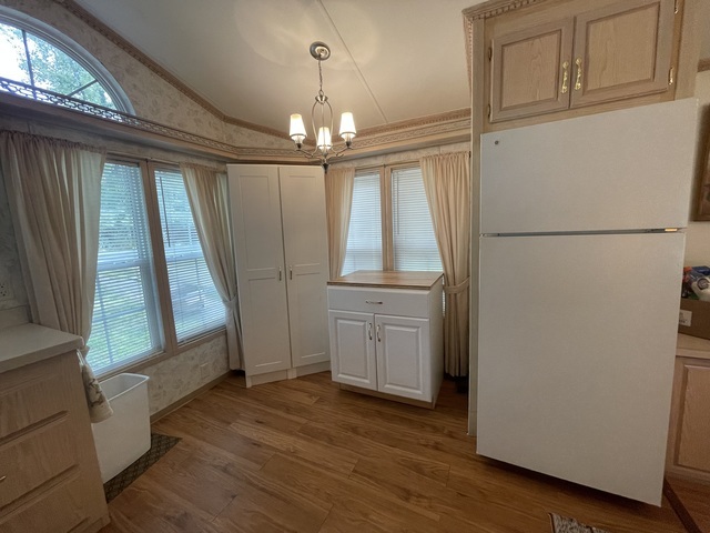 4-52 Woodhaven Lakes Sublette, IL 61367 - Photo 7 of 35 an empty room with wooden floor fan and windows